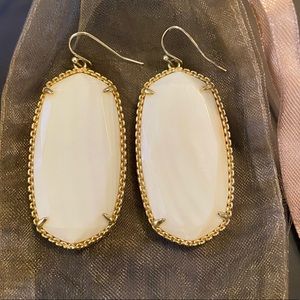 large, white Danielle Kendra Scott earrings
